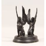 A SPELTER STAND, modelled as a pair of winged sphinx on an oval base. 7.5ins wide.