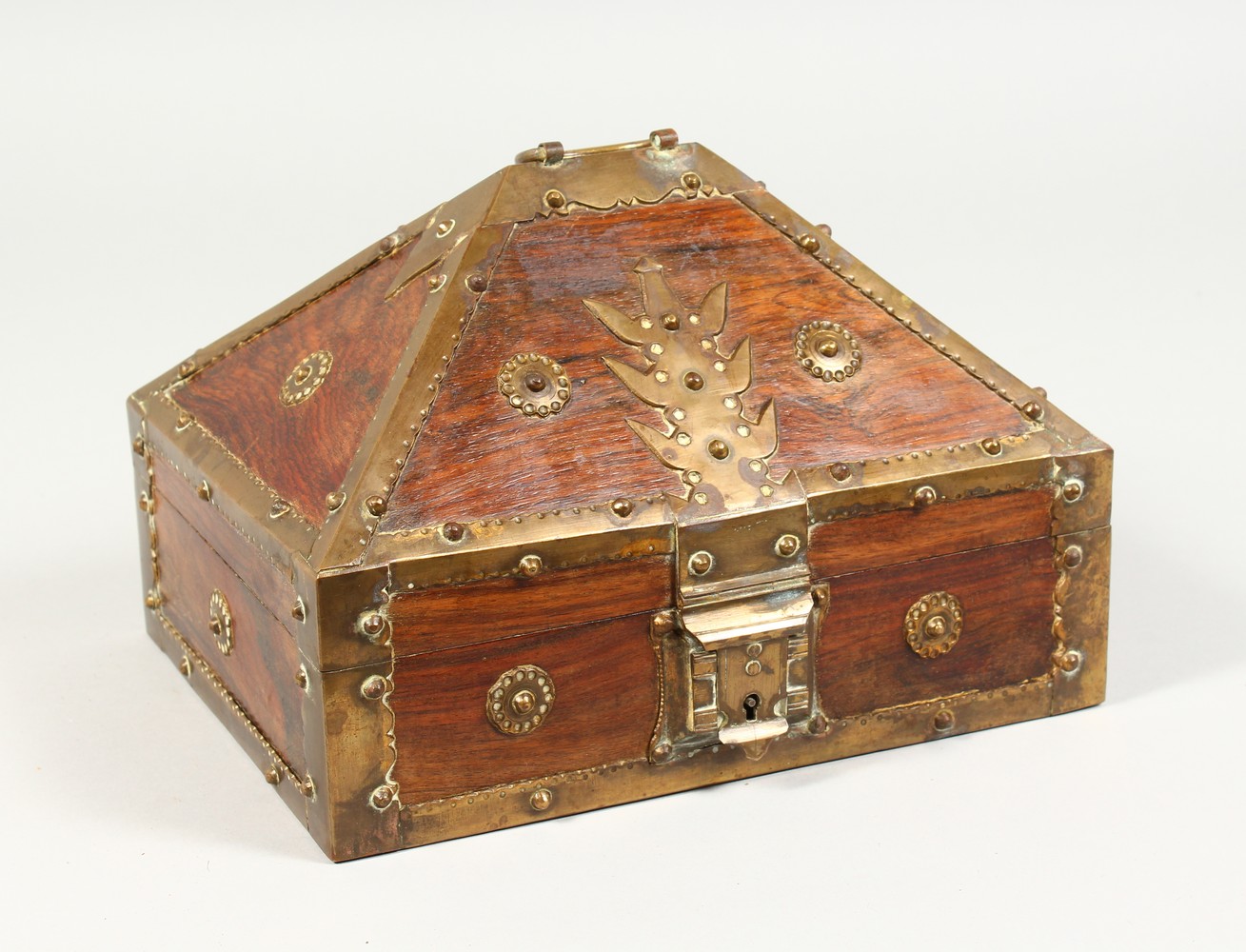 AN EASTERN BRASS BOUND WOODEN CASKET. 9ins wide.