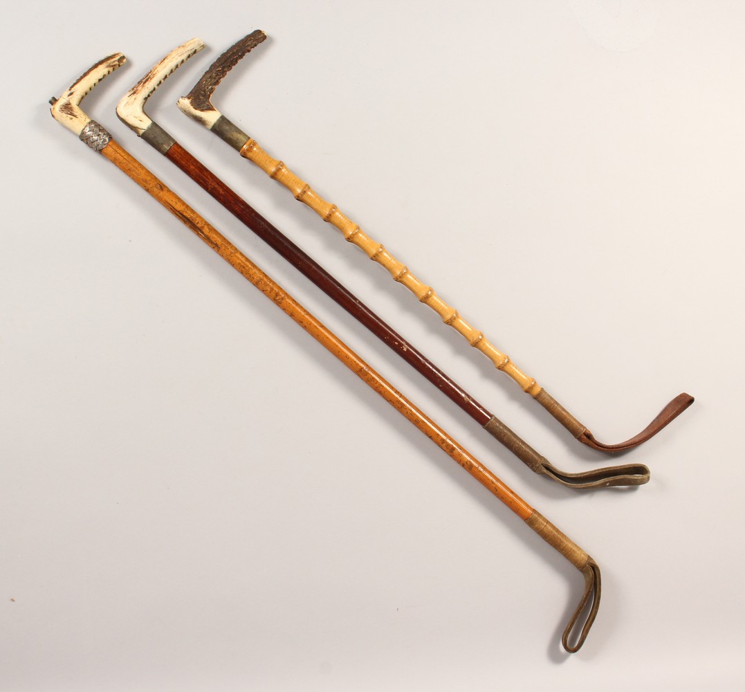 THREE ANTLER HANDLED RIDING CROPS.