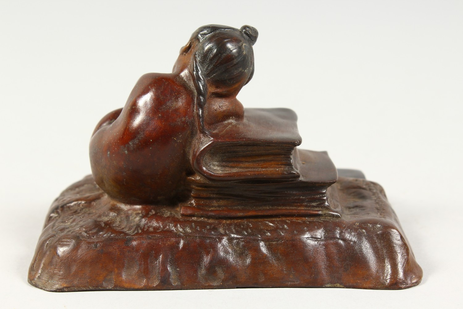 A SMALL CAST BRONZE MODEL OF A YOUNG GIRL ASLEEP AGAINST A PILE OF BOOKS. 5ins wide. - Image 3 of 6