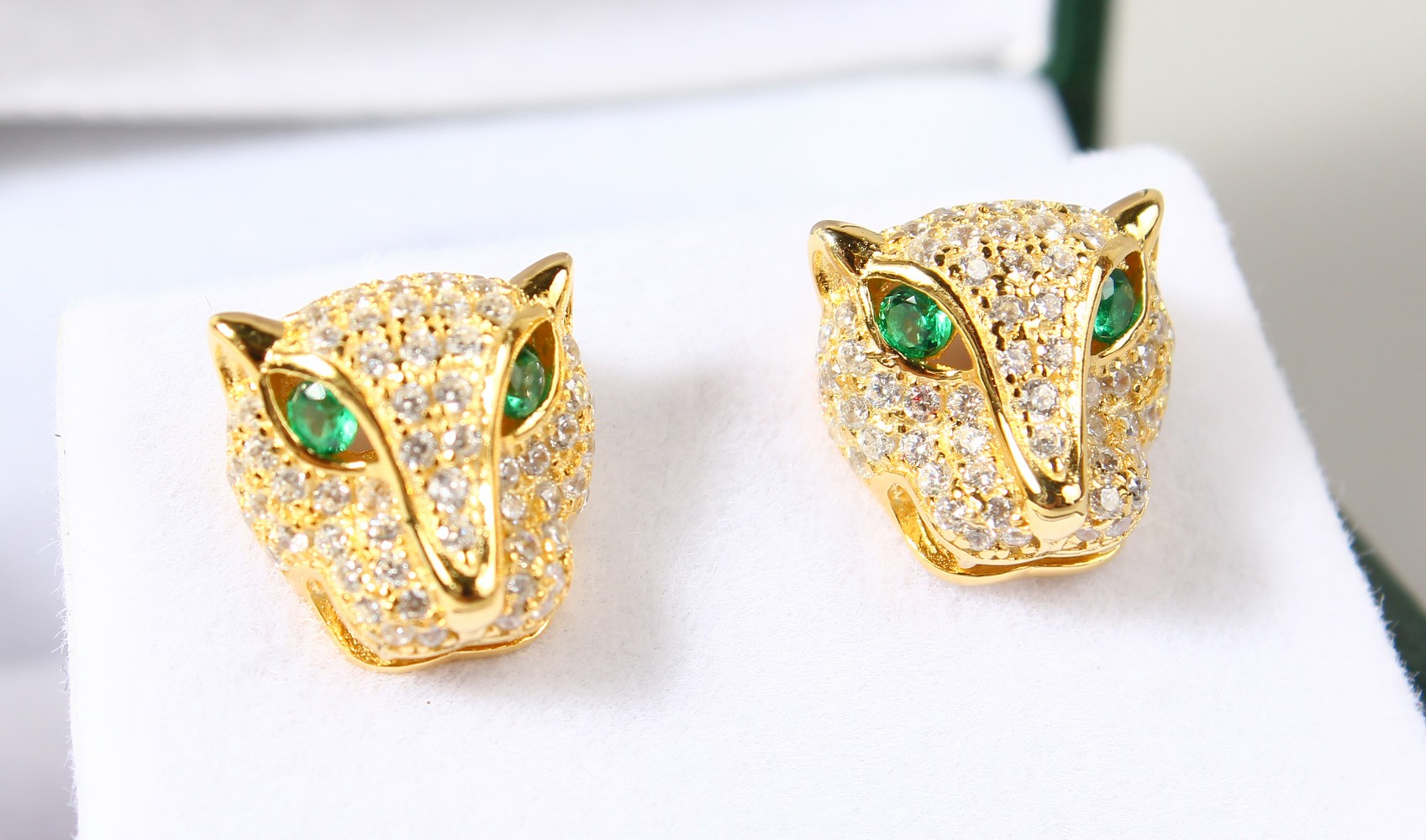 A PAIR OF SILVER GOLD PLATED PANTHER EARRINGS.