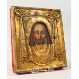 AN 18TH CENTURY RUSSIAN ICON, with silver gilt cover. 5.5ins x 5ins.