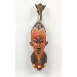 A CARVED AND PAINTED TRIBAL MASK, with elephant head finial. 25ins high.