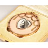 A VERY GOOD GOLD AND PINK GUILLOCHE ENAMEL SMALL CIRCULAR PHOTOGRAPH FRAME, with heart shape