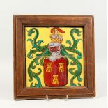 A 19TH CENTURY FAIENCE TILE PLAQUE, in two parts, depicting a Coat of Arms, later framed. 14ins x