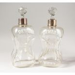 A PAIR OF DEWAR'S WHISKY HOURGLASS DECANTERS, with silver collars, marks rubbed. 10.5ins high.