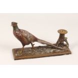AN EARLY 20TH CENTURY PAINTED SPELTER TABLE LIGHTER, in the form of a pheasant by a tree stump.