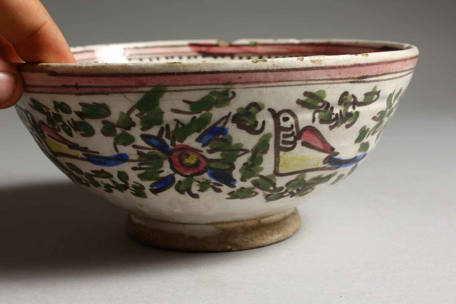 AN EARLY ISLAMIC POTTERY CIRCULAR BOWL, painted with birds. 7.5ins diameter. - Image 4 of 7