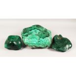 A LARGE NATURALISTIC PIECE OF MALACHITE, partially carved to form a dish, and two similar pieces (