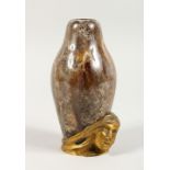 AN UNUSUAL SMALL TREACLE GLAZED POTTERY VASE, the base with applied bronze female bust, signed