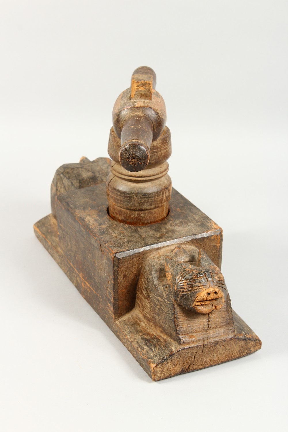 AN UNUSUAL AFRICAN CARVED WOOD FIGURAL TWIN-HANDLED PESTLE AND MORTAR. 15ins long. - Image 4 of 7
