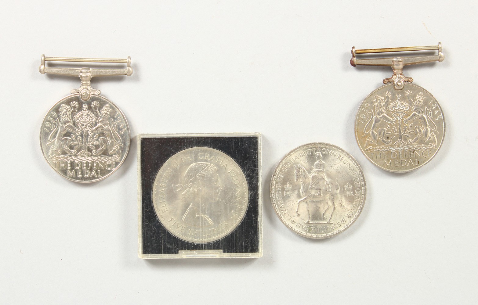 TWO WWII DEFENCE MEDALS, and two five shilling coins (4).