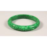 AN APPLE GREEN JADE BANGLE. 3.25ins wide.