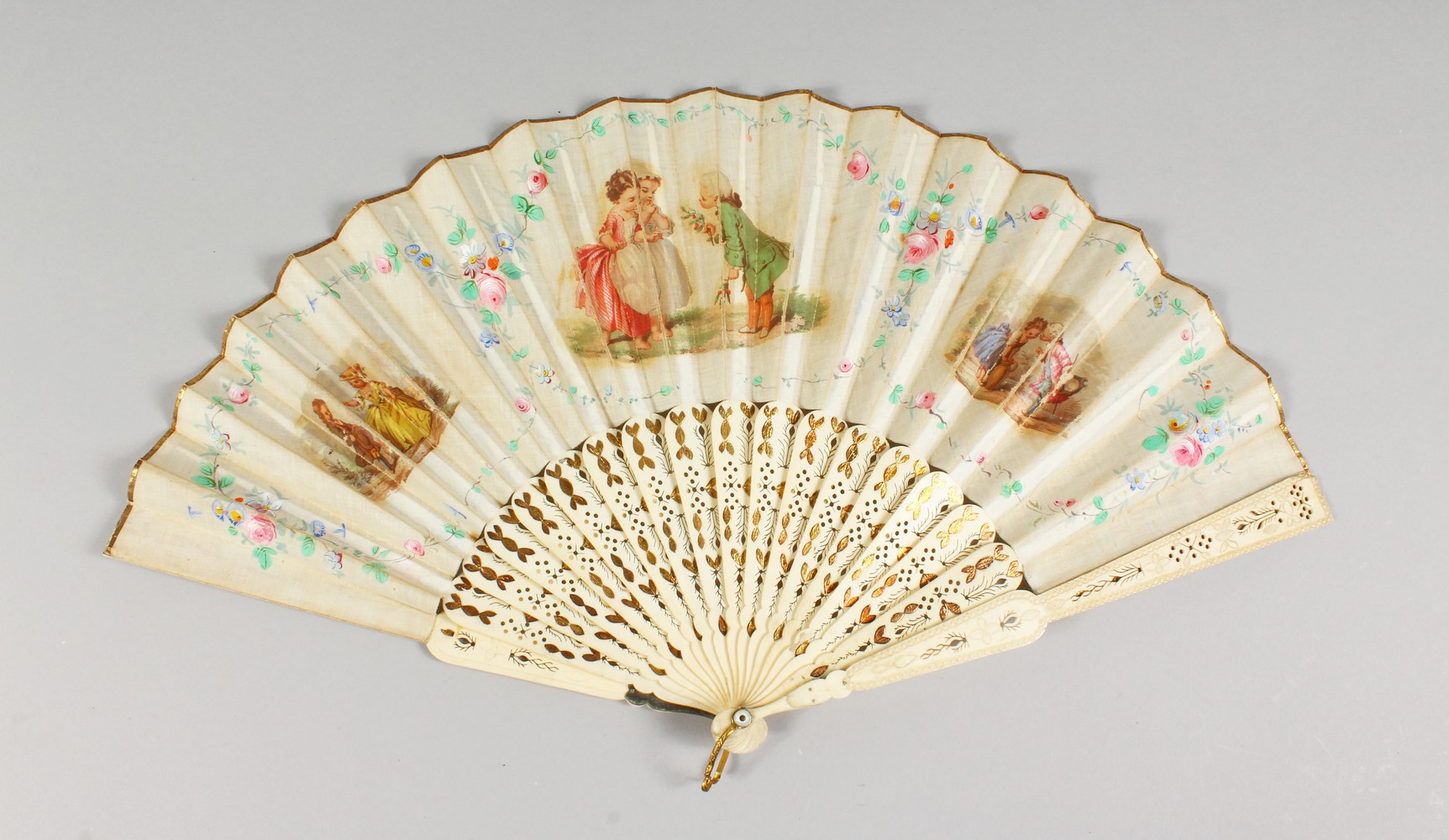 A VICTORIAN BONE FAN, painted with children. 10.5ins long.