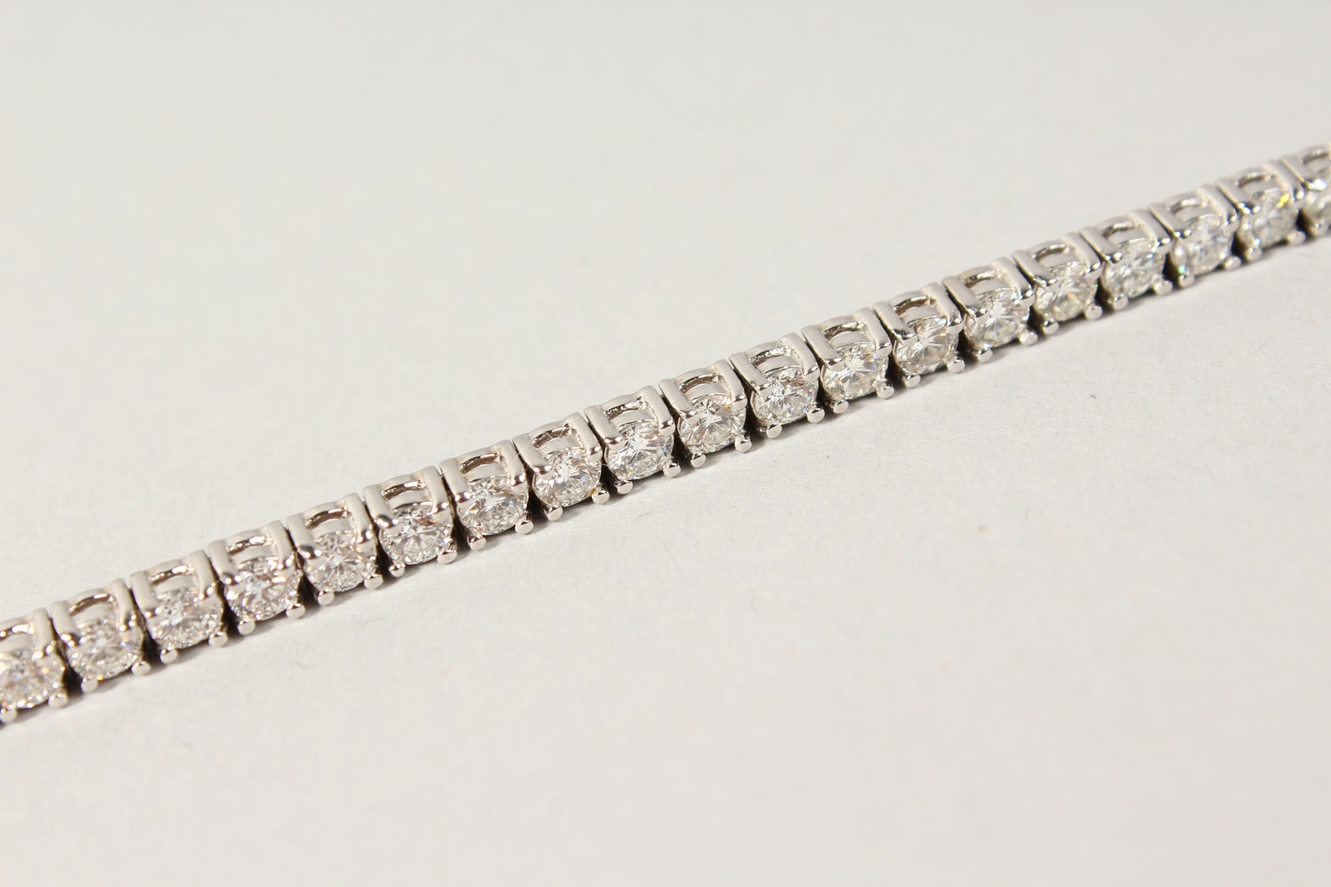 AN 18CT WHITE GOLD DIAMOND LINE BRACELET, with forty-nine diamonds, approx. 6CTS, G/H Colour, V1- - Image 8 of 19