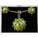 A SILVER PERIDOT SET PENDANT, on chain, and EAR STUDS.
