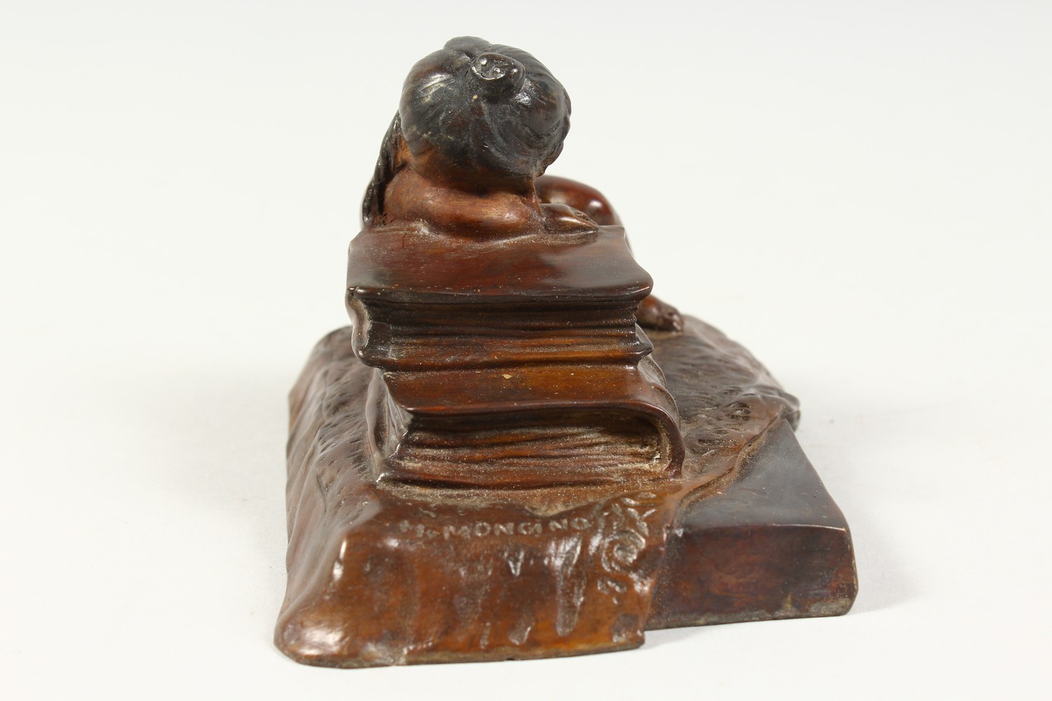 A SMALL CAST BRONZE MODEL OF A YOUNG GIRL ASLEEP AGAINST A PILE OF BOOKS. 5ins wide. - Image 4 of 6