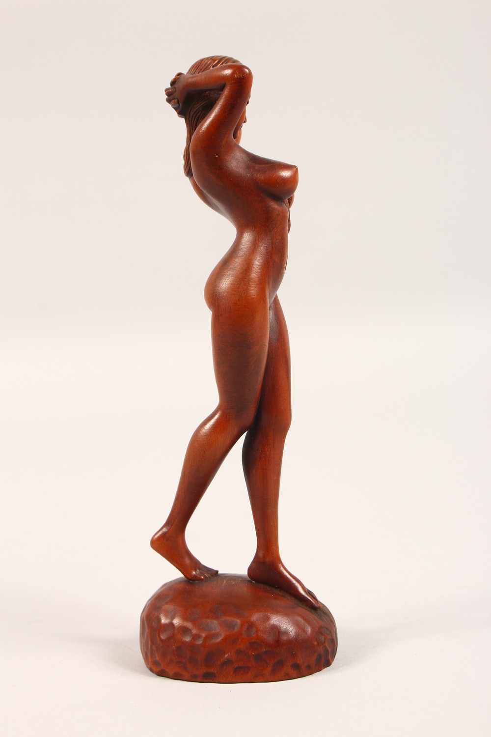 A SMALL CARVED WOOD FIGURE, standing female nude. 7ins high. - Image 4 of 4