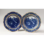 A PAIR OF CAUGHLEY BLUE AND WHITE PLATES, decorated with a complex Oriental landscape with an