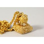A GOLD PLATED LION SEAL ON A CHAIN.