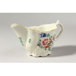 A LOW WORCESTER CHELSEA EWER, painted with coloured flowers, no mark.