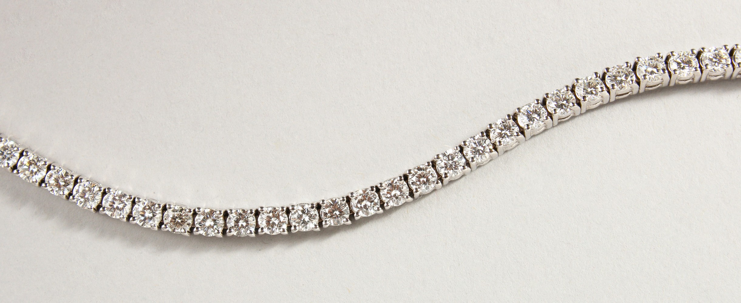 AN 18CT WHITE GOLD DIAMOND LINE BRACELET, with forty-nine diamonds, approx. 6CTS, G/H Colour, V1-