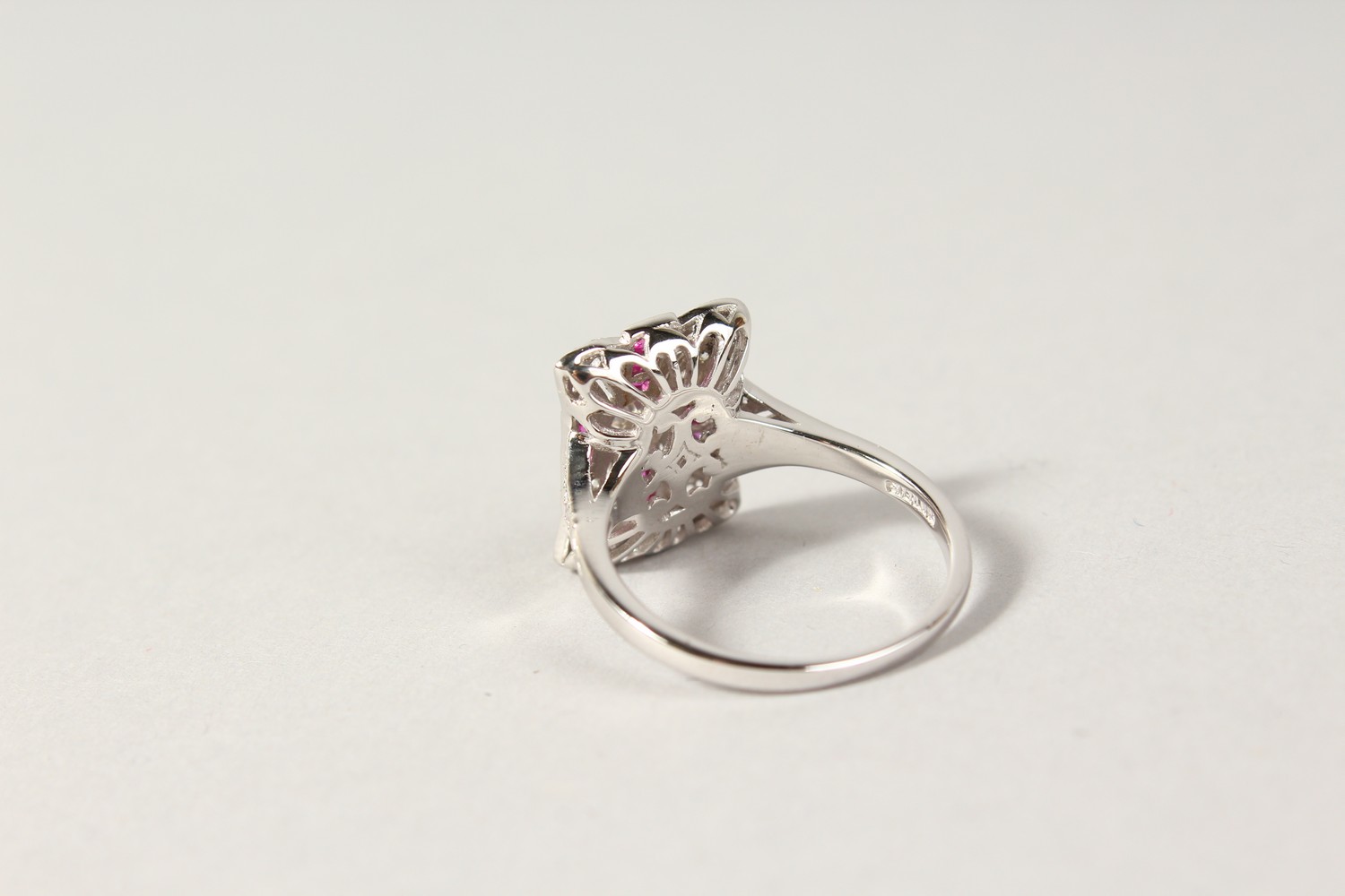 A SILVER ART DECO DESIGN FAUX RUBY AND CZ RING. - Image 2 of 2