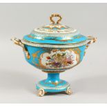 A SEVRES STYLE PALE BLUE GROUND PEDESTAL TUREEN AND COVER, decorated with classical trophies. 12.