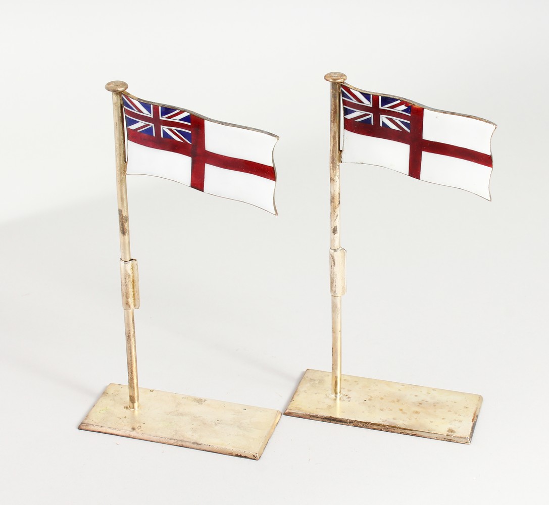 A PAIR OF SILVER PLATED AND ENAMEL PLACE NAME HOLDERS, modelled as white ensigns raised on