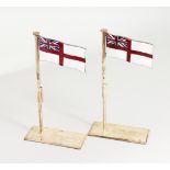 A PAIR OF SILVER PLATED AND ENAMEL PLACE NAME HOLDERS, modelled as white ensigns raised on