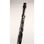 AN AFRICAN CARVED WOOD FIGURAL WALKING STICK. 34.5ins long.