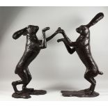 AN IMPRESSIVE LARGE PAIR OF BRONZE BOXING HARES. 35ins high.