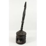 A GOOD AFRICAN CARVED HARDWOOD PESTLE AND MORTAR, with long turned and carved shaft and drum