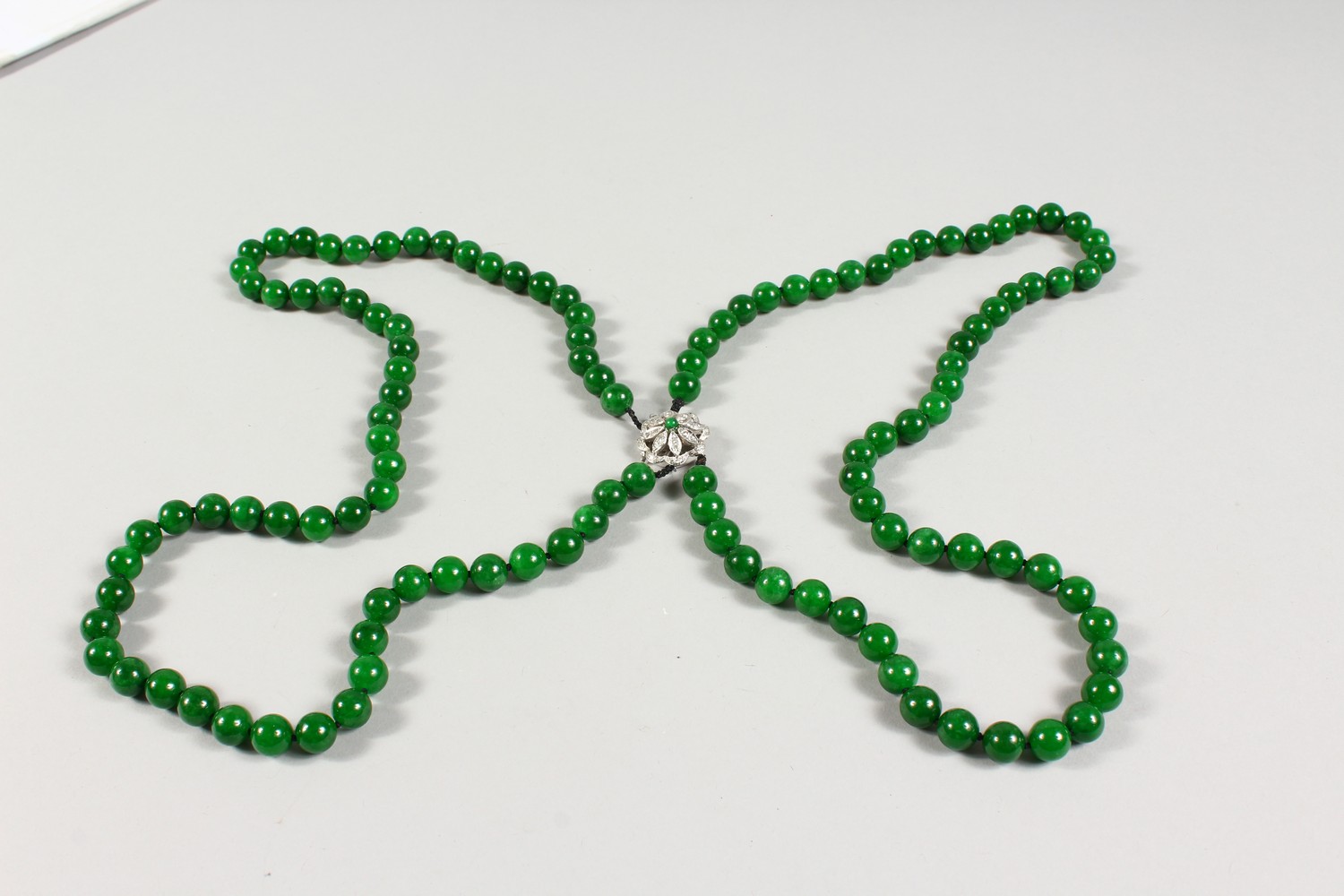 A GOOD DOUBLE ROW OF JADE BEADS, with 18ct white gold and diamond clasp. 25ins long. - Image 3 of 4
