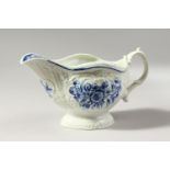 A WORCESTER BLUE AND WHITE SAUCEBOAT, crisply moulded with overlapping scales, painted with