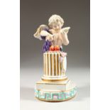 A CONTINENTAL GROUP OF A WINGED CUPID, symbolic of WINTER, standing before a column, on an oval