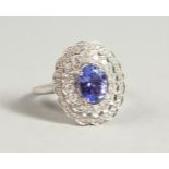 AN 18CT WHITE GOLD, DIAMOND AND TANZANITE RING.