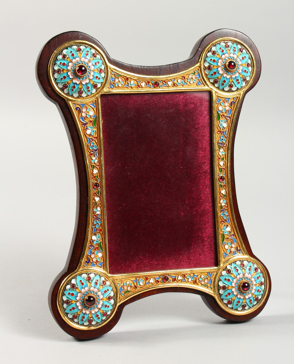 A RUSSIAN SILVER GILT AND ENAMEL DECORATED PHOTOGRAPH FRAME. 9.25ins high x 7ins wide.