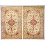 A PAIR OF PERSIAN TABRIZ CARPETS, beige ground with a central medallion and floral decoration (