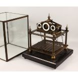 A MODERN "ROLLING BALL" CLOCK, housed in a glass case. 16.5ins wide x 20ins high x 16ins deep.