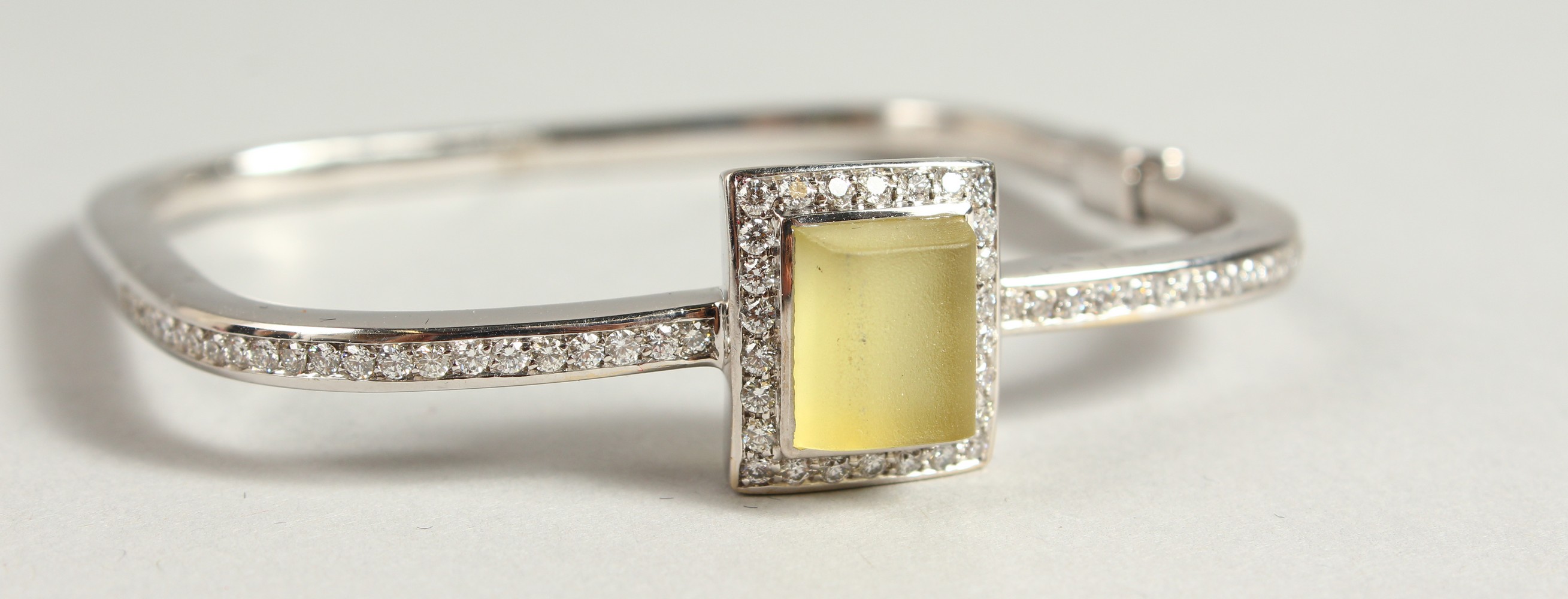 AN 18CT WHITE GOLD DIAMOND SET BANGLE, with large lemon quartz stone.