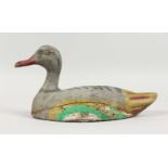 A CARVED AND PAINTED DUCK DECOY. 11ins long.
