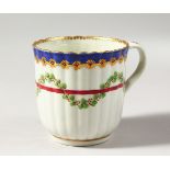 A WORCESTER REEDED COLOURED COFFEE CUP, with blue and gilt border, having a red line entwined with