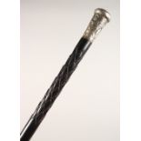 A CARVED EBONY WALKING STICK, with embossed Chinese white metal top. 34ins long.