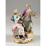 A MEISSEN FIGURE GROUP OF A GARDENER AND LADY, the man holding a basket of flowers, the lady