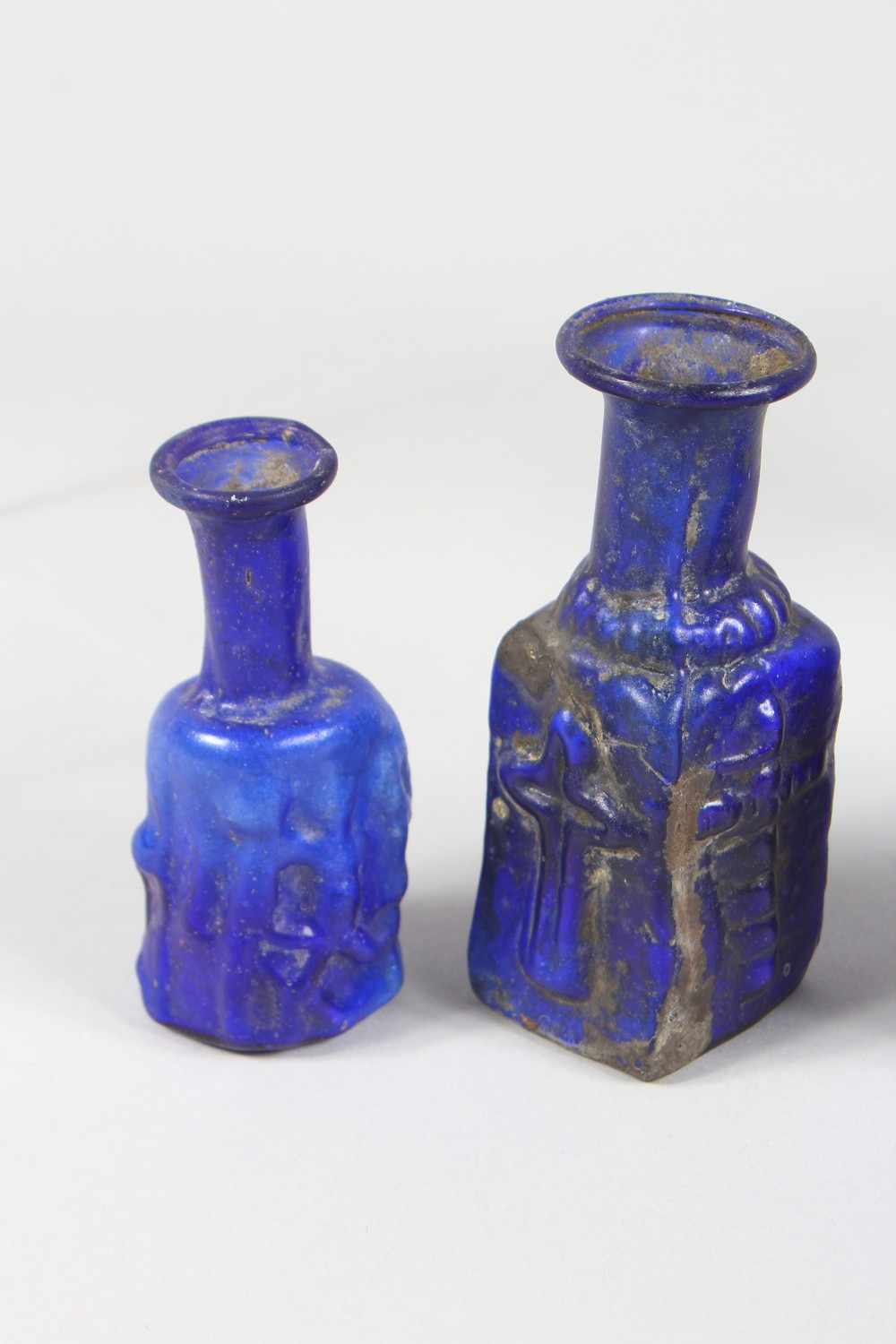 A COLLECTION OF ROMAN GLASS BOTTLES, some with moulded decoration as heads, bunches of grapes (10). - Image 10 of 10