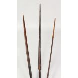 THREE PAPUA NEW GUINEA CARVED BARBED SPEARS. Longest: 8ft 3ins (3).