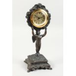 A BRONZED SPELTER CLOCK on a stand. 9.5ins high.