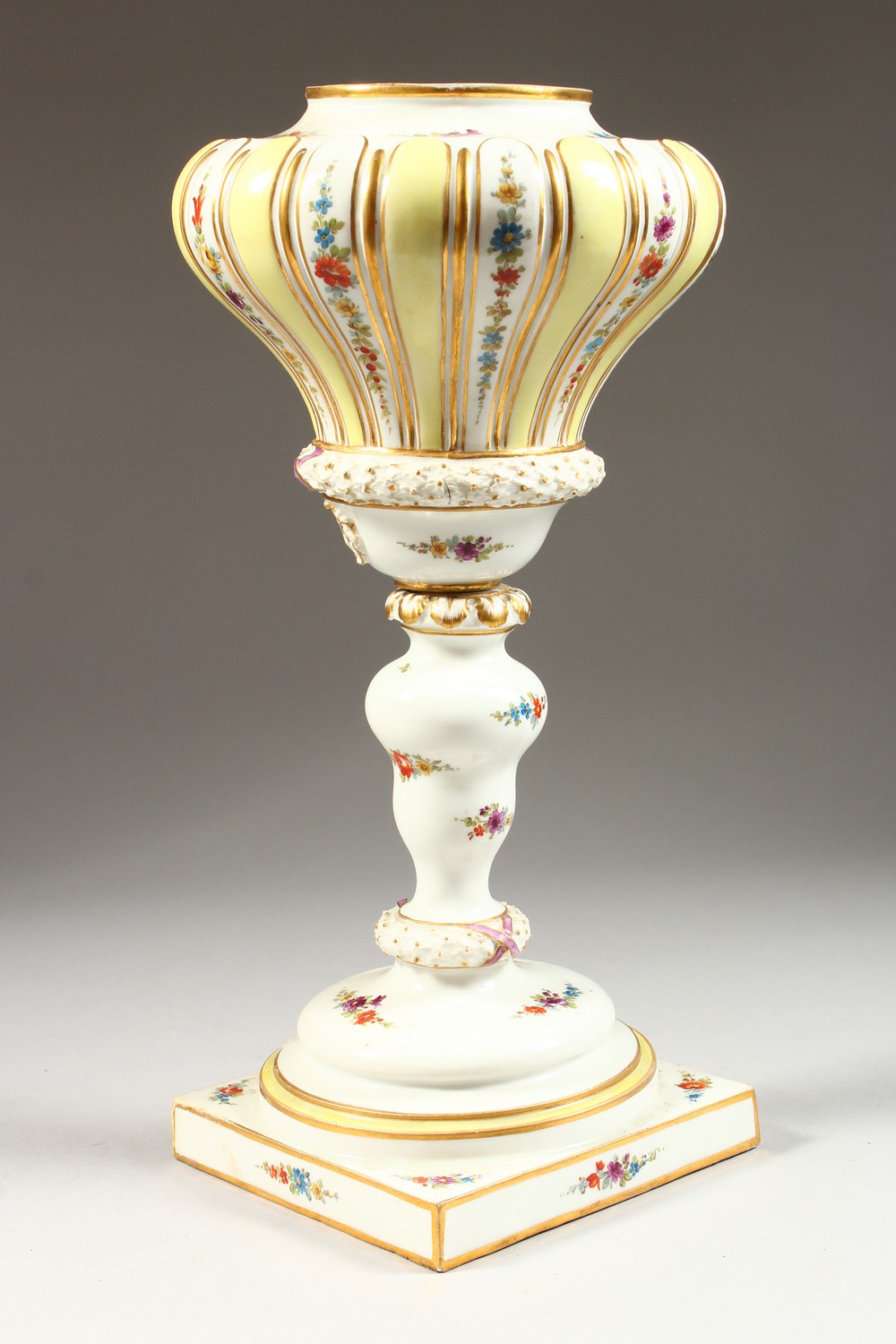 A LARGE 19TH CENTURY MEISSEN PORCELAIN LAMP BASE, sprigged with flowers, on a square base. Cross