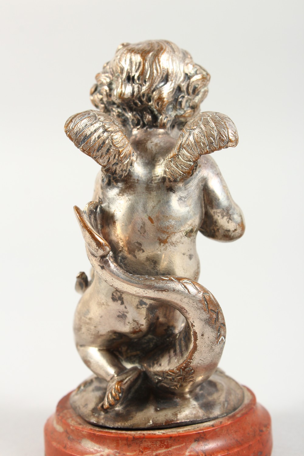 A SILVERED CAST METAL MODEL OF CUPID RIDING ON A DOLPHIN, on a marble base. 5ins high overall. - Image 3 of 3